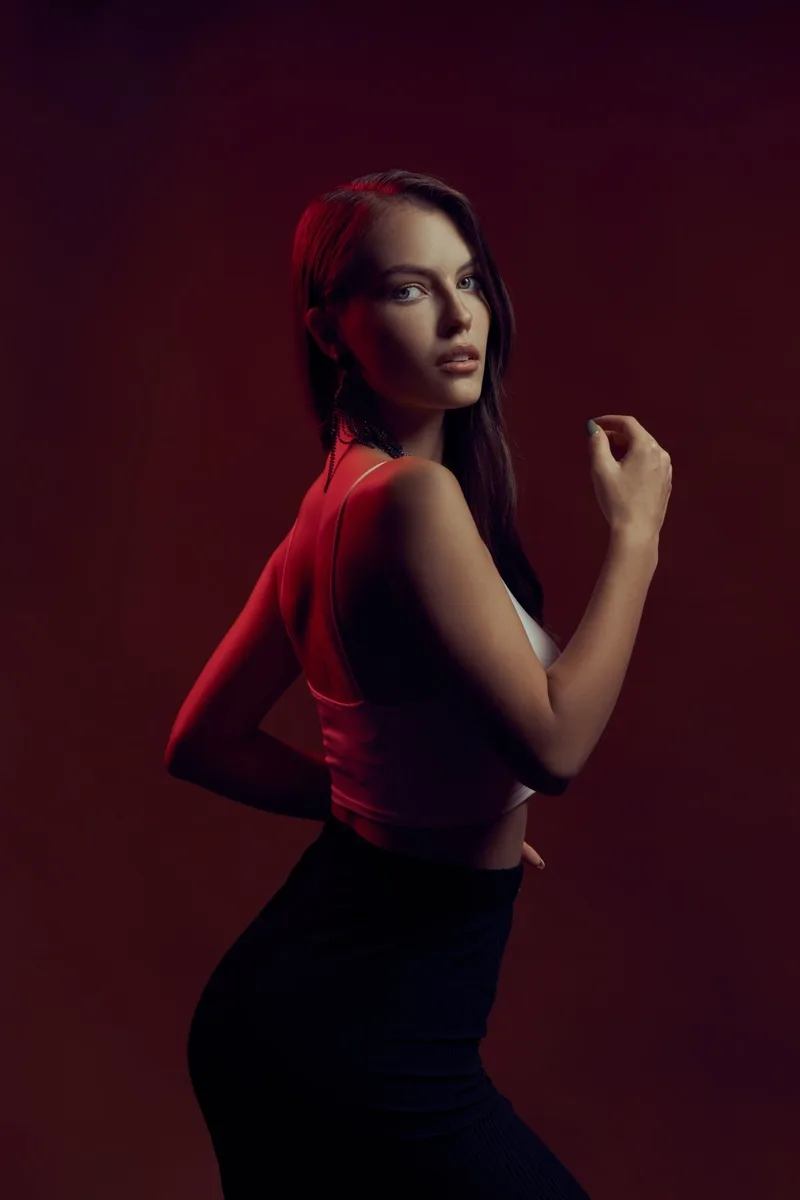 Sofia Kolchevskaya in a red top against a burgundy backdrop